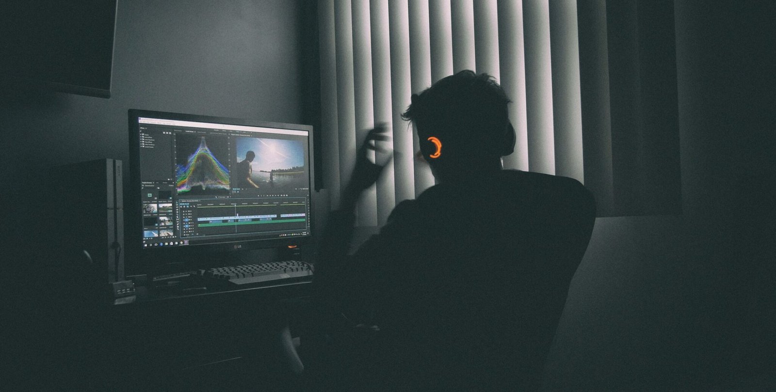 Editor working on a video timeline in a dark edit suite
