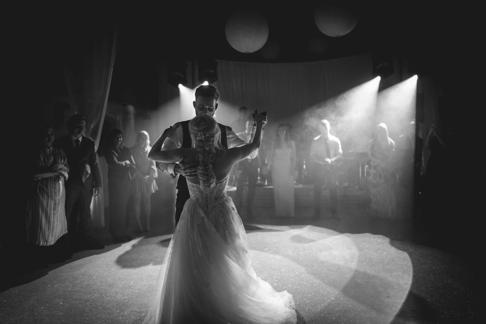 Black and white first dance in a crowded reception hall