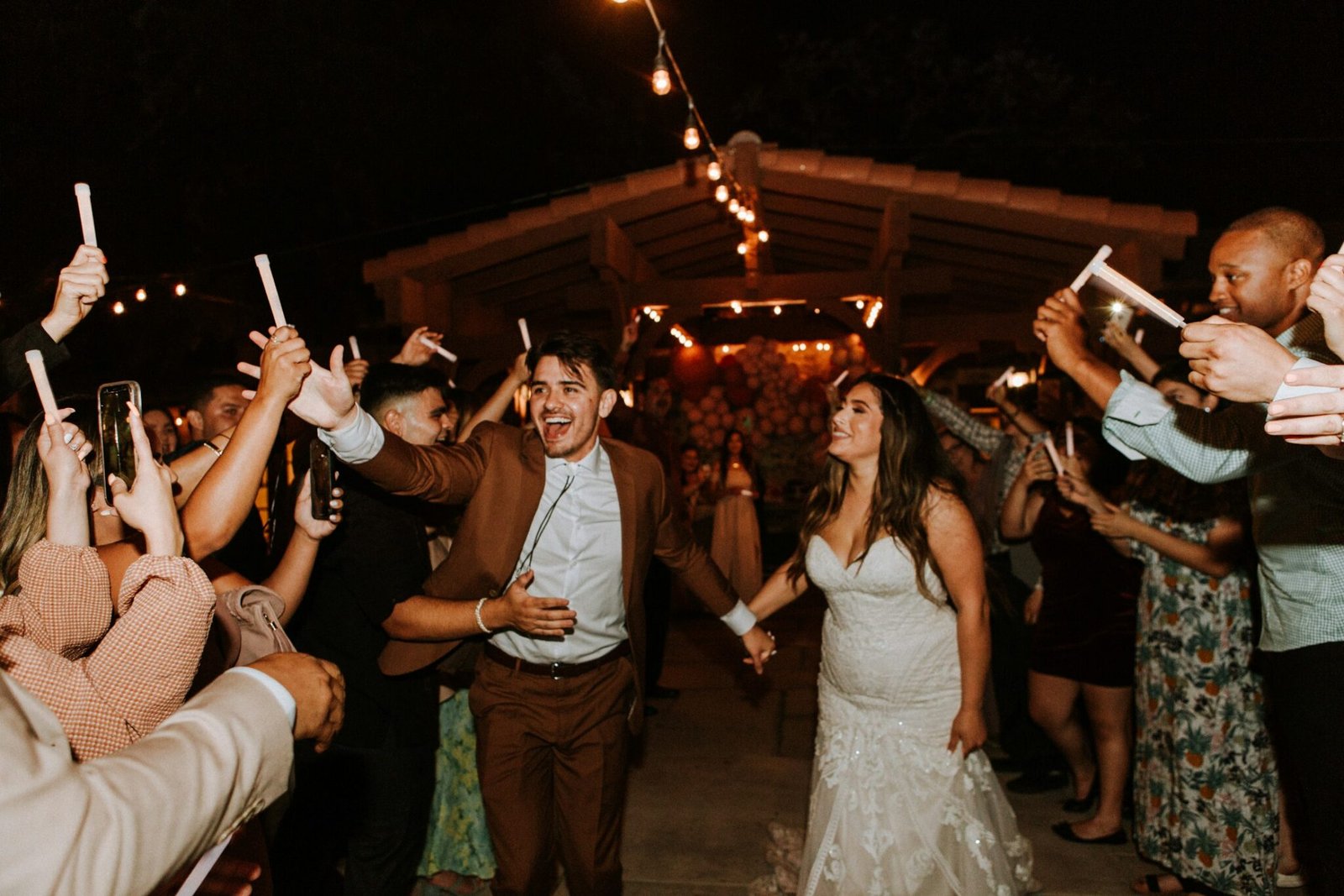 Guests dancing at a wedding reception at night